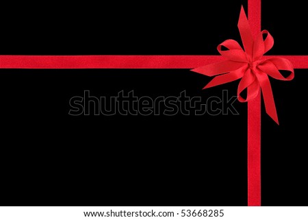 Red satin ribbon with double bow isolated over black background.