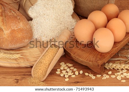 Natural food of egg, rye bread, granary flour, brown sugar with scattered oat flakes, corn and wheat.