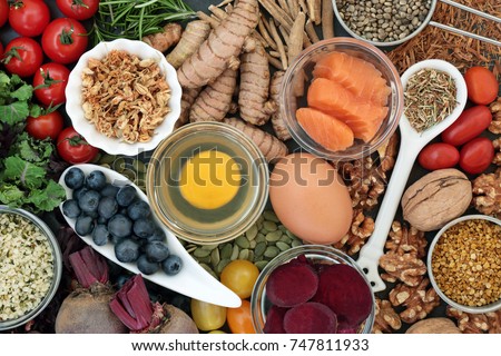 Food to promote brain power and memory concept with nuts, seeds, herbs, vegetables, fruit, dairy and fish. Super foods high in vitamins, antioxidants, omega 3 fatty acids, anthocyanins. Top view.