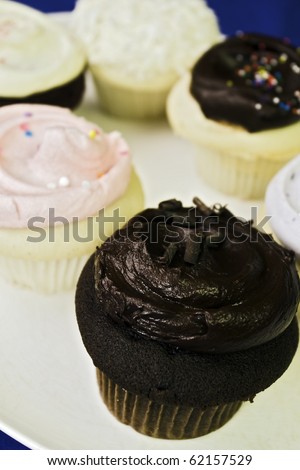 a plate full of delicious cupcakes.  This shot was taken with a short depth of field at very close range.