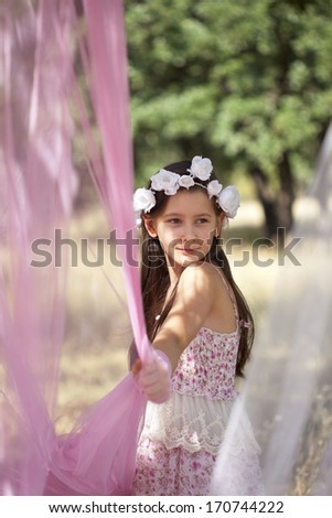 Sweet little girl on the field with romantic dress
