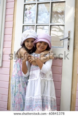 Sweet little girls in front of her little house for playtime