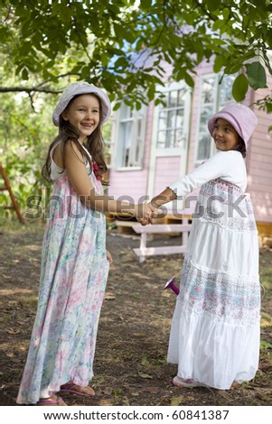 Sweet little girls in front of him little house for playtime