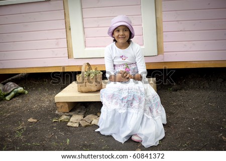 Sweet little girl in front of her little house for playtime