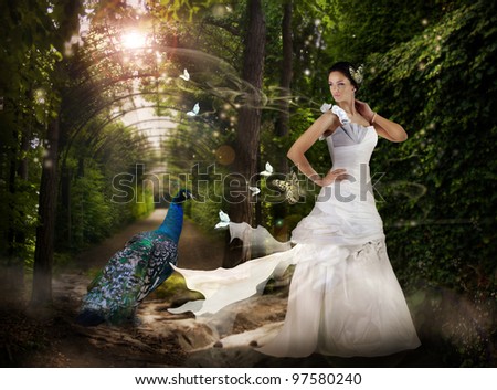 Magic scene in the wild park with fairy girl and peacock.