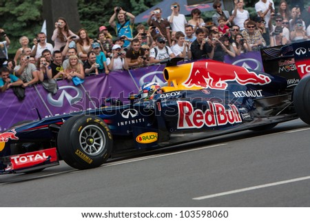 UKRAINE,KIEV - MAY 19: Scuderia Toro Rosso driver Daniel Ricciardo drive the RB7 of Red Bull Racing Fires Up the Streets of Kiev, Champions Parade, May 19, 2012 in Kiev, Ukraine