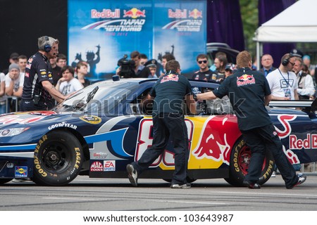 UKRAINE,KIEV - MAY 19: Daniel Ricciardo drive a NASCAR of Red Bull Racing Fires Up the Streets of Kiev making even more smoke and noise, Champions Parade, May 19, 2012 in Kiev, Ukraine