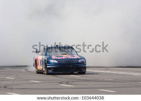 UKRAINE,KIEV - MAY 19: Daniel Ricciardo drive a NASCAR of Red Bull Racing Fires Up the Streets of Kiev making even more smoke and noise, Champions Parade, May 19, 2012 in Kiev, Ukraine