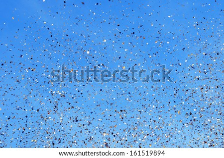 falling golden confetti in the city festival on blue sky background #3