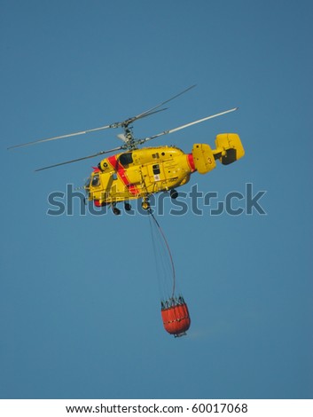 MACEIRA, PORTUGAL - AUGUST 14 : Fire rescue heavy helicopter with water bucket in summer fire in Maceira August 14, 2010 in Maceira, PORTUGAL