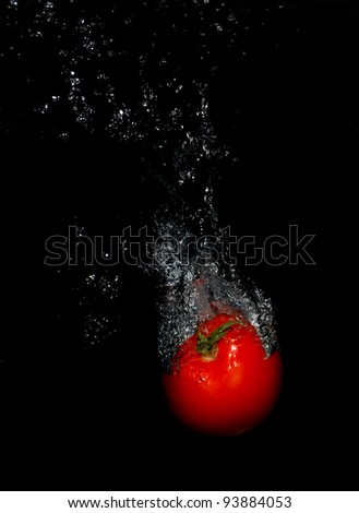tomato falling in water splash