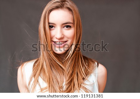 beautiful girl smiling with braces, giving a look