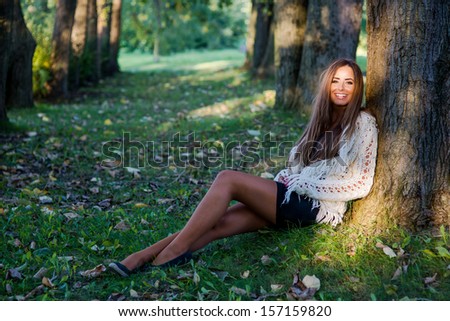 woman sitting under tree smiling