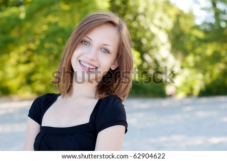 Beautiful girl wearing braces, candid portrait