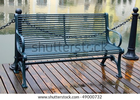 Metal bench at water side.