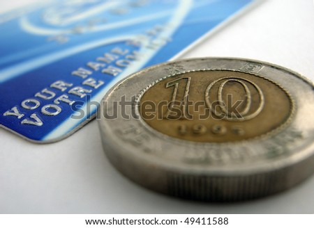 A fake creditcard with a ten dollar coin