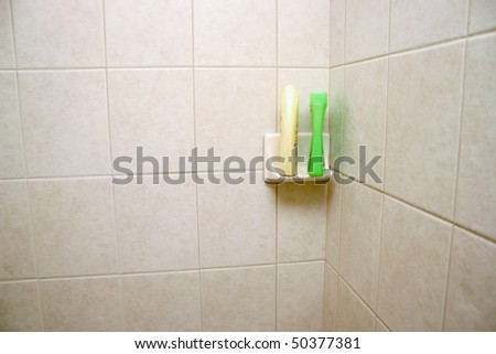 New tile shower space with shampoo shelf.