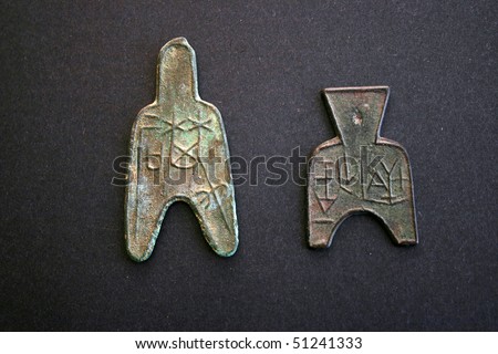 Two chinese ancient money in black background.