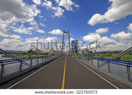 KRASNOYARSK, RUSSIA - JULY 16, 2013:  Pedestrian bridge over the Yenisei to the Tatyshev Island