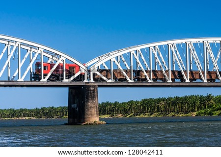 Freight train crossing the river on the bridge in eastern Madagascar