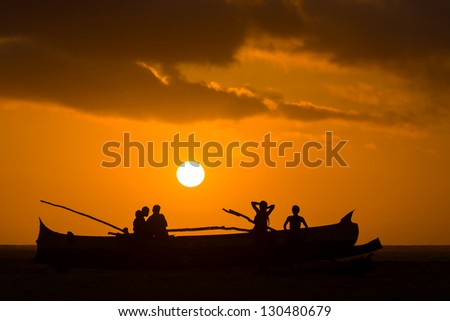 MORONDAVA, MADAGASCAR, OCT 29: Sunset on a canoe and unidentified Malagasy people on oct. 29, 2007 on the Morondava beach, western Madagascar