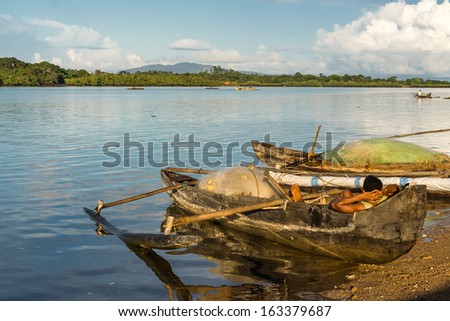 NOSY BE, MADAGASCAR - APR 4: unidentified malagasy people waiting in an outrigger canoe on april 4, 2008