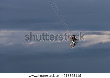 Kitesurfer jumping in the clouds