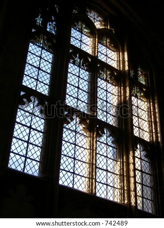 Gothic glass window in Winchester cathedral with early morning sun