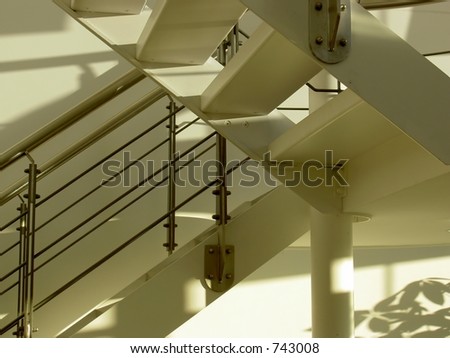 Stairs in interior of office building with sunlight and shadows