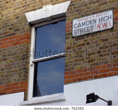 Reflection in window and Camden High Street sign in London UK