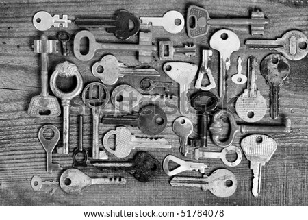 stock-photo-old-different-keys-on-wooden-board-black-and-white-51784078.jpg