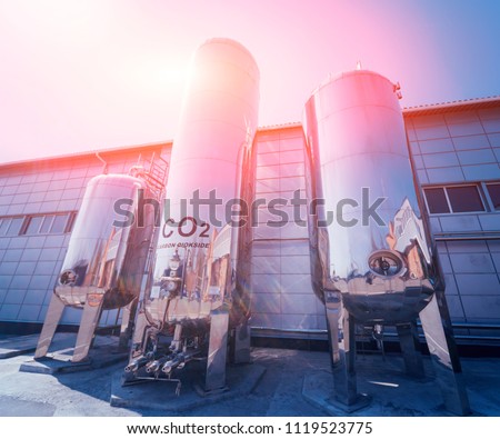 The tank with water, carbon and ladder. Equipment for beverages factory. Background