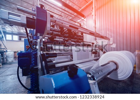 Modern automated production line in factory. Plastic bag manufacturing process. Background