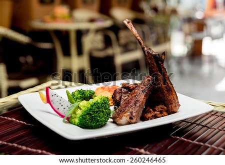 Roasted meat on the white plate. Barbecue. Restaurant