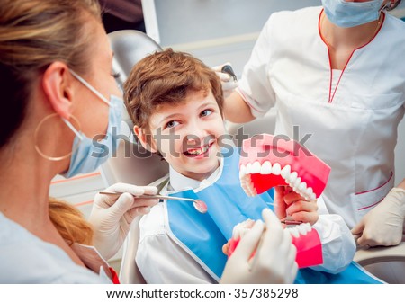 Little boy with dentures in the dental office.