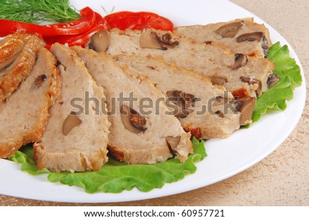 Meat loaf with lettuce on white plate