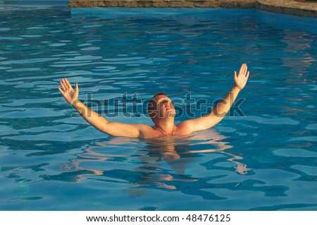 The sunbathing man in the swimming-pool