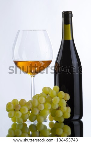 Still-life with bottle of wine, grapes and glass of white wine