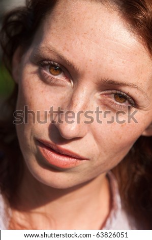 close up portrait of a freckled woman