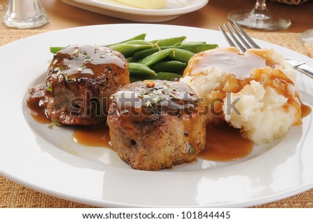 Pork tenderloin medallions with potatoes and sugar snap peas in the pod