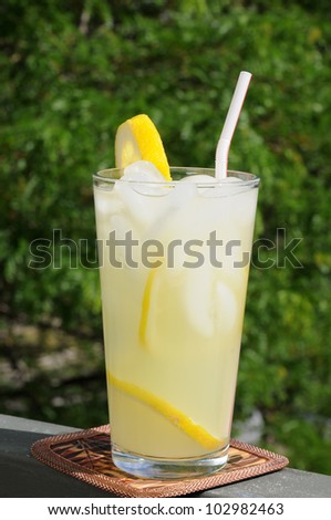 a tall glass of lemonade on the patio