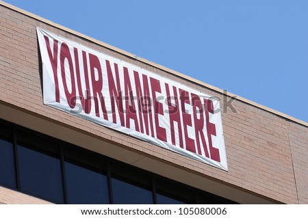 A large banner on a building saying your name here to advertise for tenants