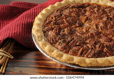 Close up shot of a pecan pie cooling on a chopping block