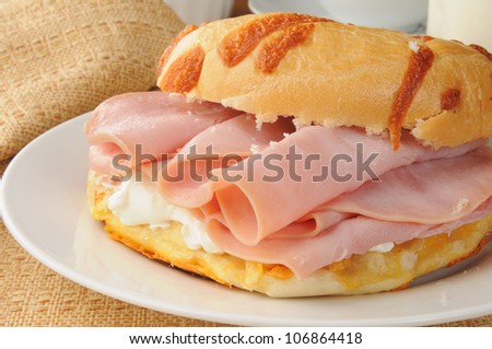 A bagel sandwich with ham and cream cheese