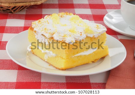 A slice of yellow cake with coffee