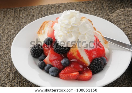 A plate of strawberry shortcake on angle food cake slices