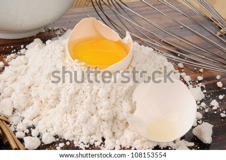 A mound of baking mix with a broken egg