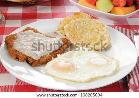 Chicken fried steak with country gravy with an english muffin