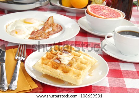 Waffles with bacon and eggs and grapefruit