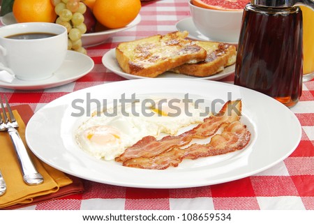 Bacon and eggs with french toast and grapefruit
